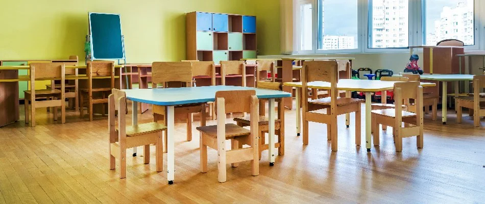 Day care center in Florida with tables, chairs, cabinets, and a chalkboard.
