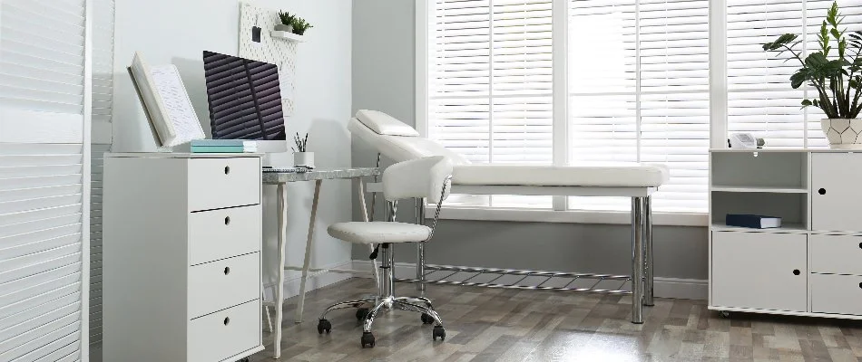 Medical office in Florida with white furniture and plants.